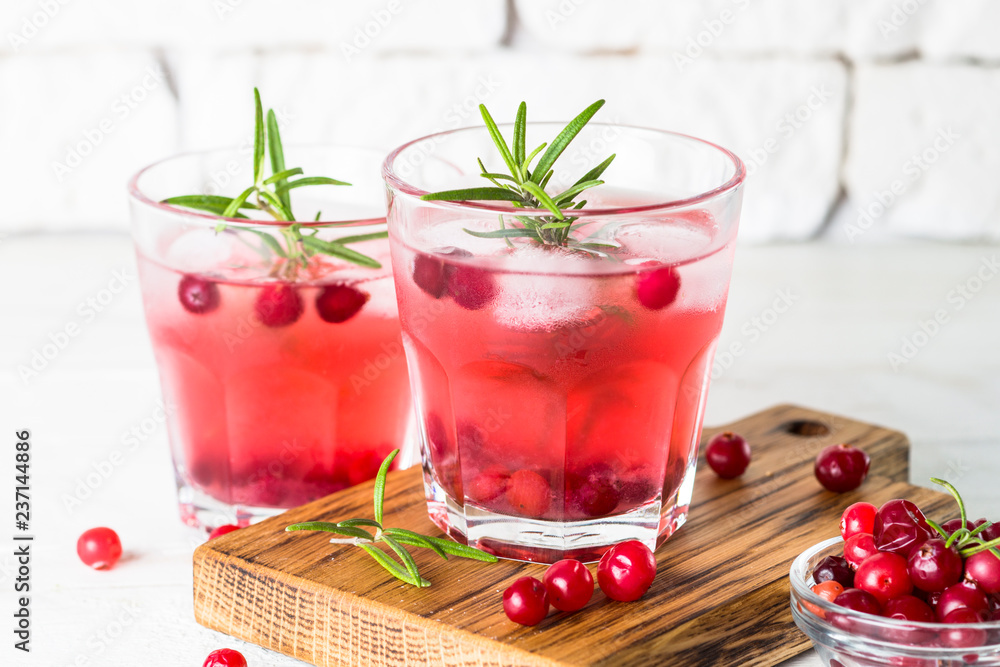 Cocktail with cranberry, vodka, rosemary and ice. Cocktail with cranberry, vodka, rosemary and ice.