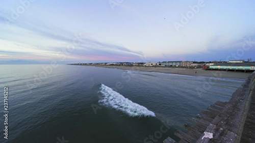 view of the ocean looking over the railing of the fishing pier 