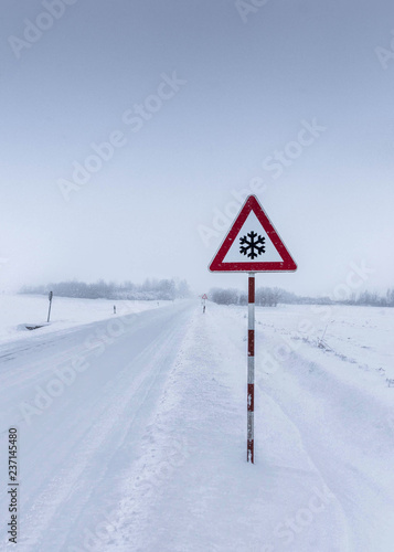 Snow road sign with snow and ice road