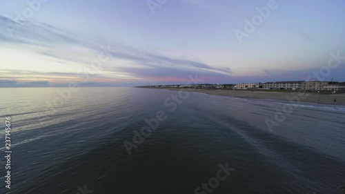 view of the ocean looking over the railing of the fishing pier 