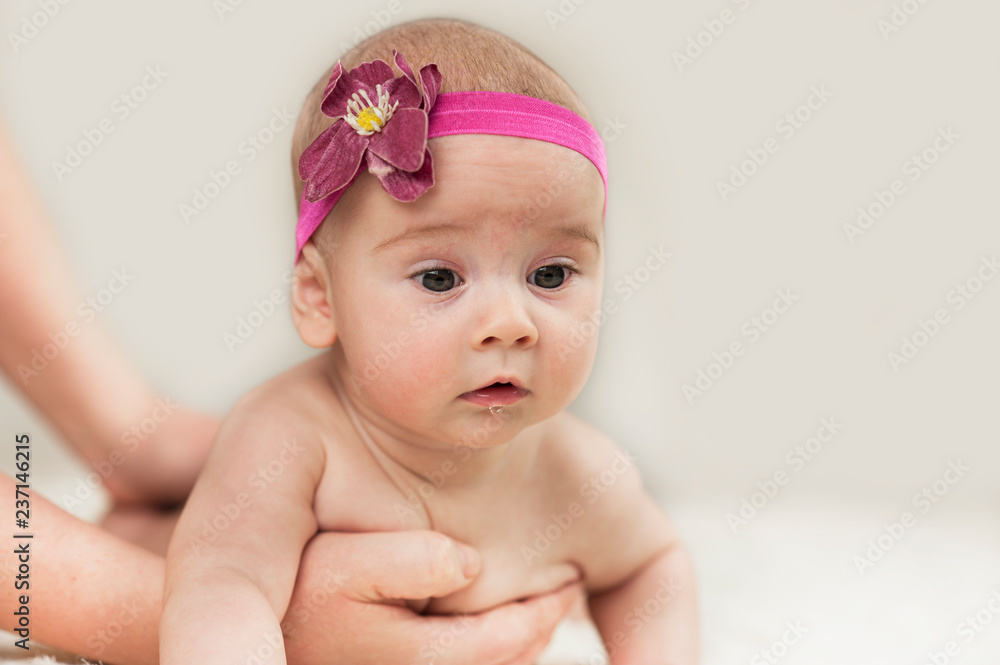 very beautiful baby learns to crawl, he has saliva on an isolated background very beautiful baby learns to crawl, he has saliva on an isolated background