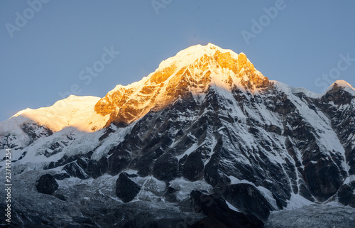 Принти на полотні Close-up view of Annapurna South montain peak against clear blue sky during sunr