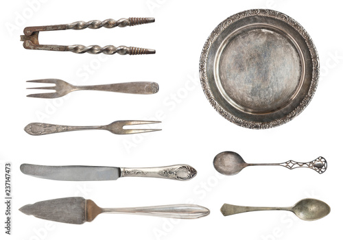 Vintage spoons, forks and plate isolated on white background. Antique silverware. Retro.