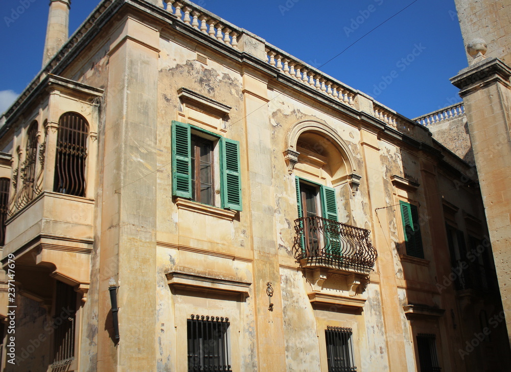 Building with traditional maltese balcony in historical part of Mdina