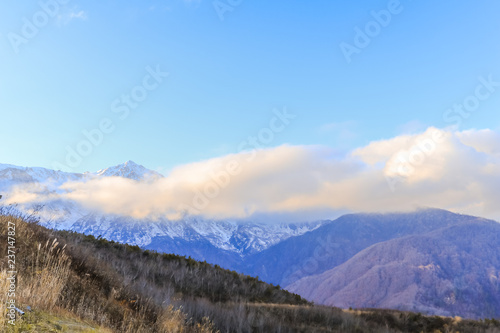Beautiful landscape view of Hakuba in the winter with snow on the mountain and blue sky background in Nagano Prefecture Japan.