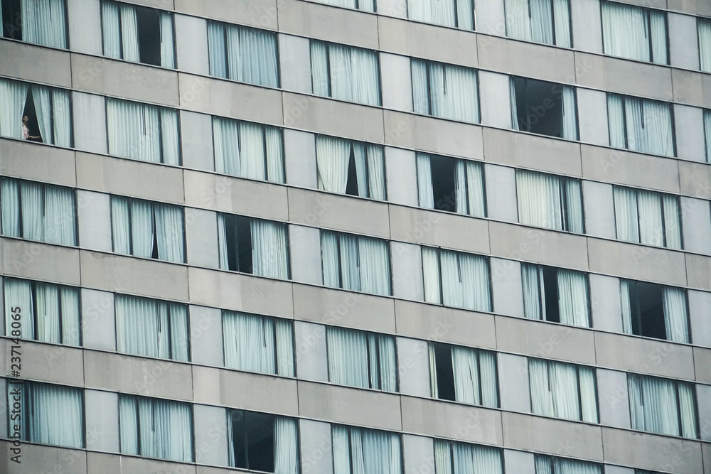 woman look out the window from hotel room woman look out the window from hotel room