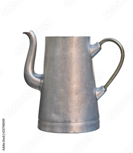 Old aluminum kettle isolated on white background. Vintage shabby dishes..