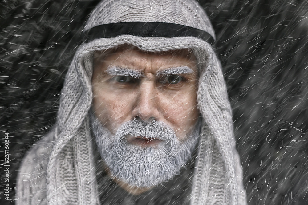 islamic man portrait / winter look man with gray beard, in traditional oriental clothes, religion concept, studio setting