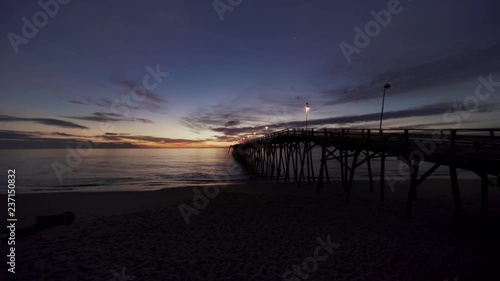 Dawn on the beach by the pier