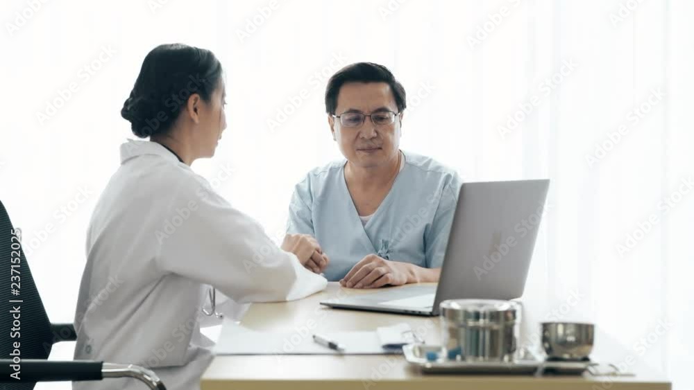 Doctor with patient. Young female medical doctor talking to a senior patient at hospital. Sharing medical test result via computer. Senior care medical and insurance concept. Doctor with patient. Young female medical doctor talking to a senior patient at hospital. Sharing medical test result via computer. Senior care medical and insurance concept.