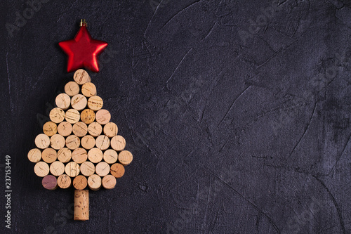 Christmas tree made of  wine corks. Mockup, layout, flat lay. New Year winter season concept, background