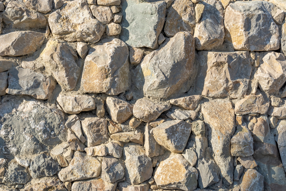The wall is made of large stones The wall is made of large stones