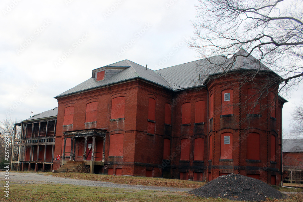Boarded up and abandoned brick mental hospital asylum building Boarded up and abandoned brick mental hospital asylum building