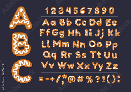 Christmas or New Year gingerbread cookies alphabet with arabic numbers and signs. Set of isolated alphabet, cookie figures, covered icing-sugar on dark background. Full English ABC.
