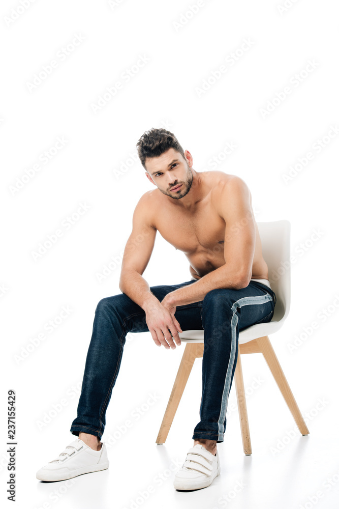 handsome man sitting on chair and looking at camera isolated on white handsome man sitting on chair and looking at camera isolated on white