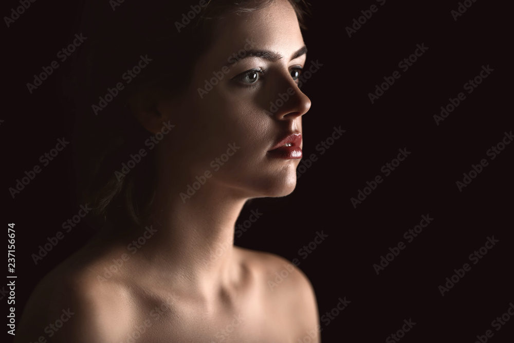 Fototapeta premium Portrait of beautiful young woman on dark background