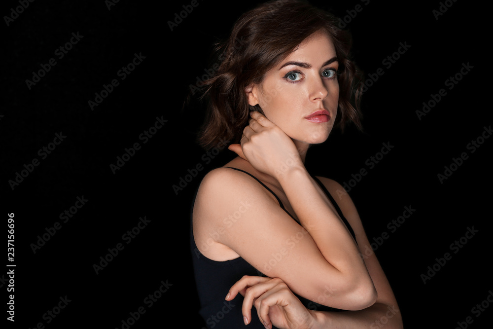 Portrait of beautiful young woman on dark background Portrait of beautiful young woman on dark background