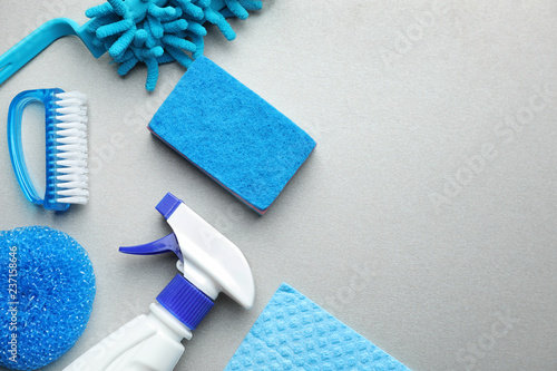 Cleaning supplies on grey background