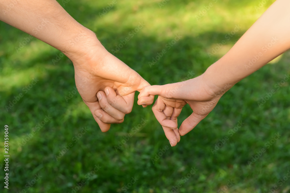 Man and woman holding hands outdoors Man and woman holding hands outdoors