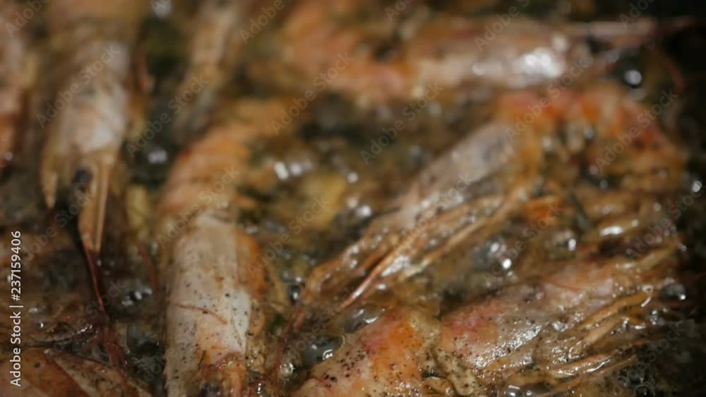 Cooking king prawns with dill and garlic in a pan with olive oil. Cooking king prawns with dill and garlic in a pan with olive oil.