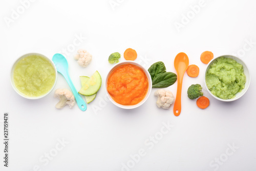 Flat lay composition with healthy baby food on white background
