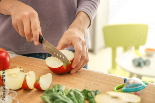 Woman slicing fresh red app...