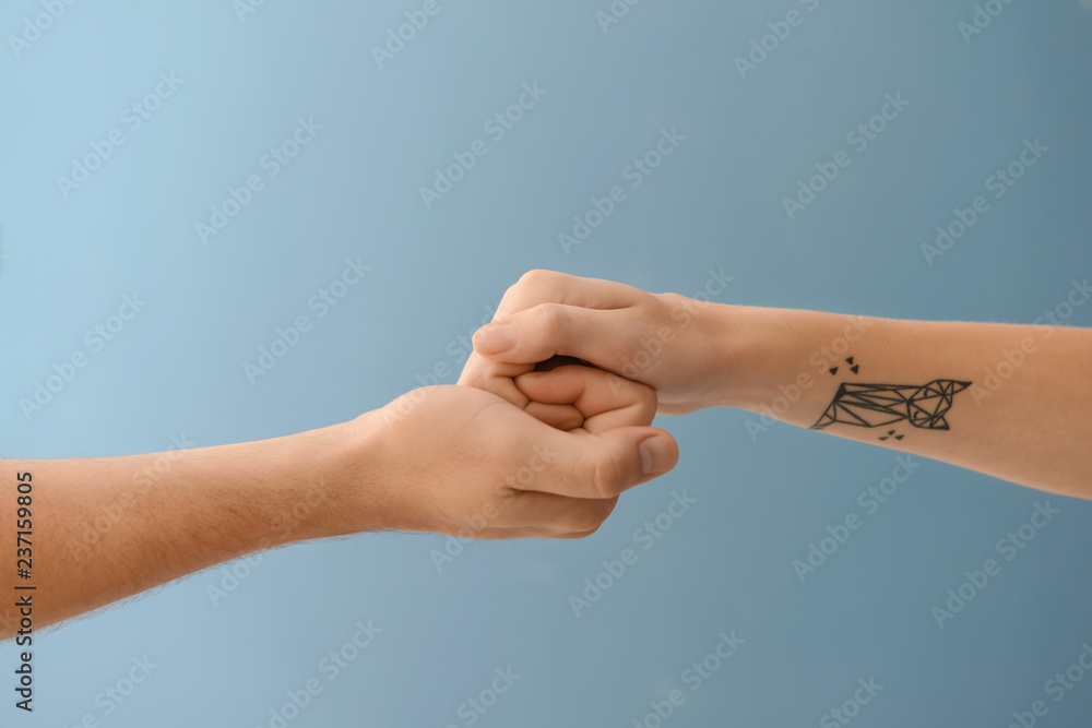 Man and woman holding hands on color background. Concept of support and help Man and woman holding hands on color background. Concept of support and help