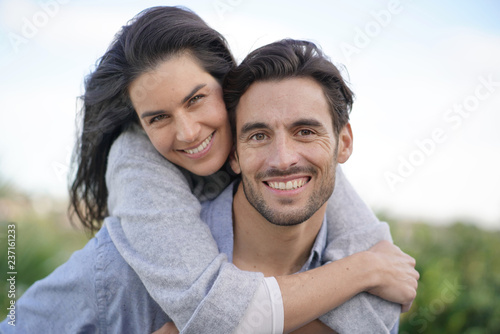  Portrait of gorgeous couple outdoors piggybacking