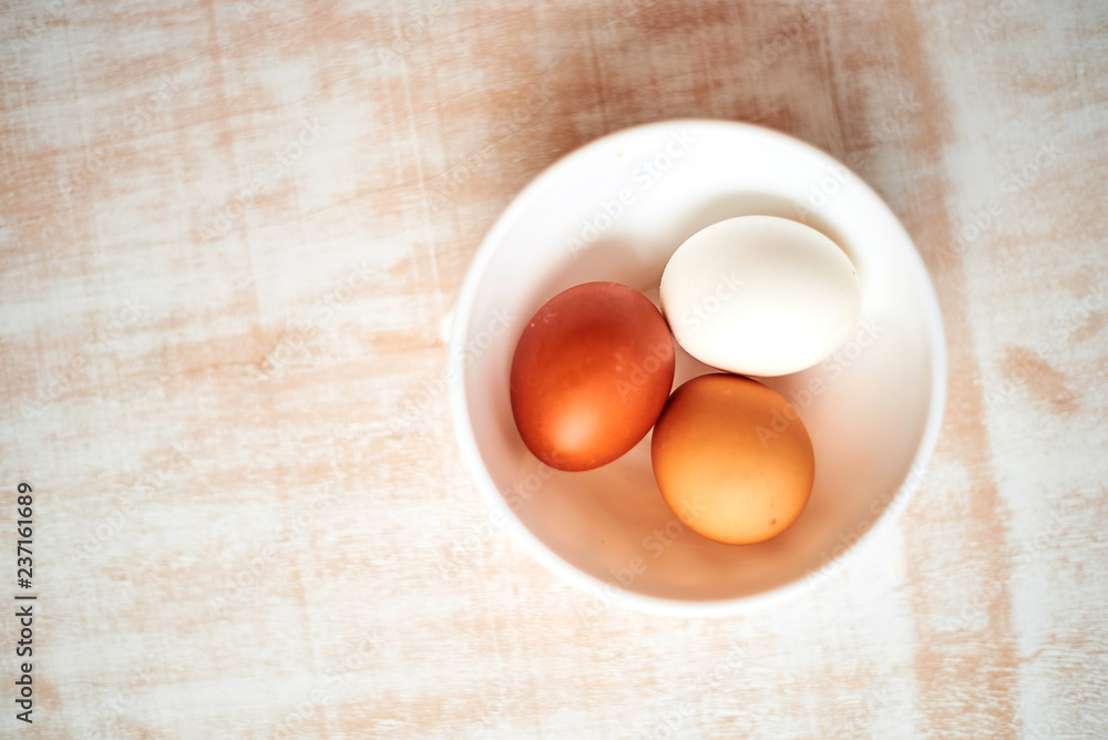 eggs in a bowl on wooden table eggs in a bowl on wooden table
