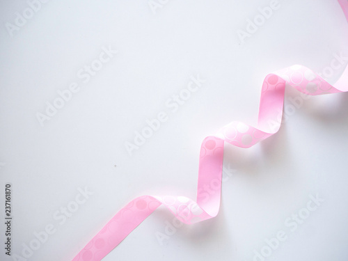 Pink curly ribbon on a white