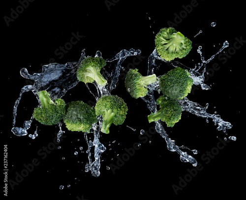 Broccoli with water splash or explosion flying in the air isolated on black background