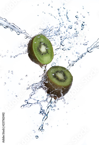 Kiwi fruit with water splash flying in the air isolated on white background