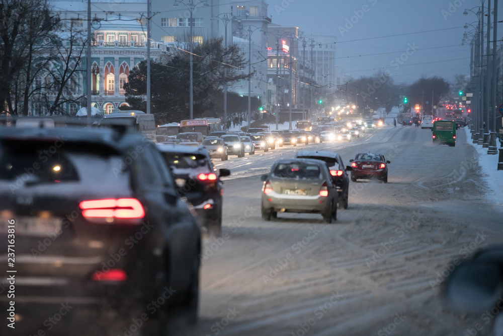 snow transport road city / landscape in a night city in winter, cars on the road in traffic jam in cold weather, snow