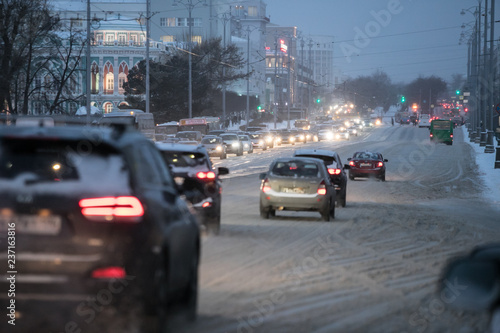 snow transport road city / landscape in a night city in winter, cars on the road in traffic jam in cold weather, snow