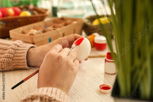 Woman painting Easter eggs ...