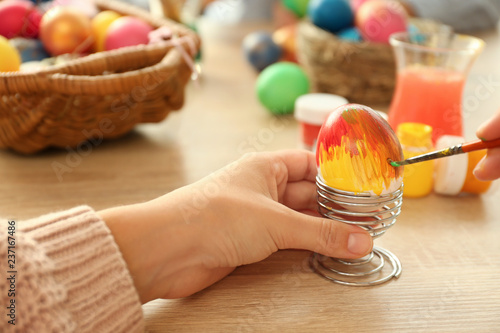 Woman painting Easter eggs ...