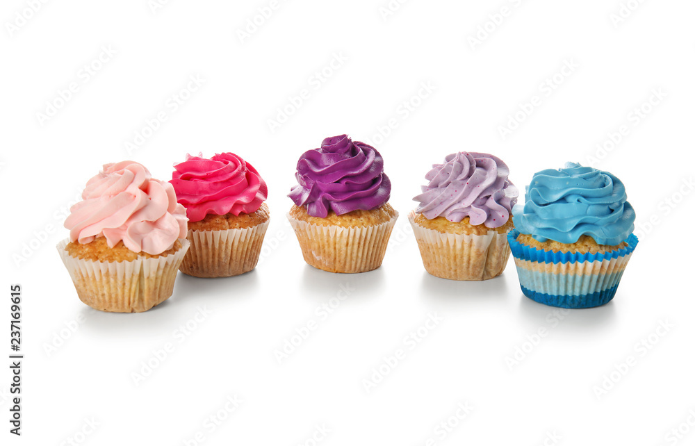 Delicious colorful cupcakes on white background