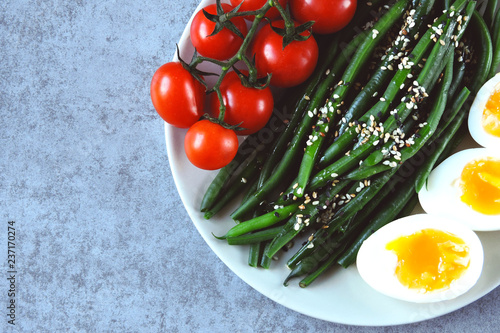 Colorful, healthy foods. flatlay. Buddha bowl with eggs, green beans and cherry tomatoes