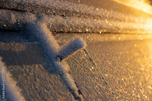 door handle and keyhole are covered with frost. severe frosts. door freezes. icy handle and lock covered with snowflakes. blurred background
