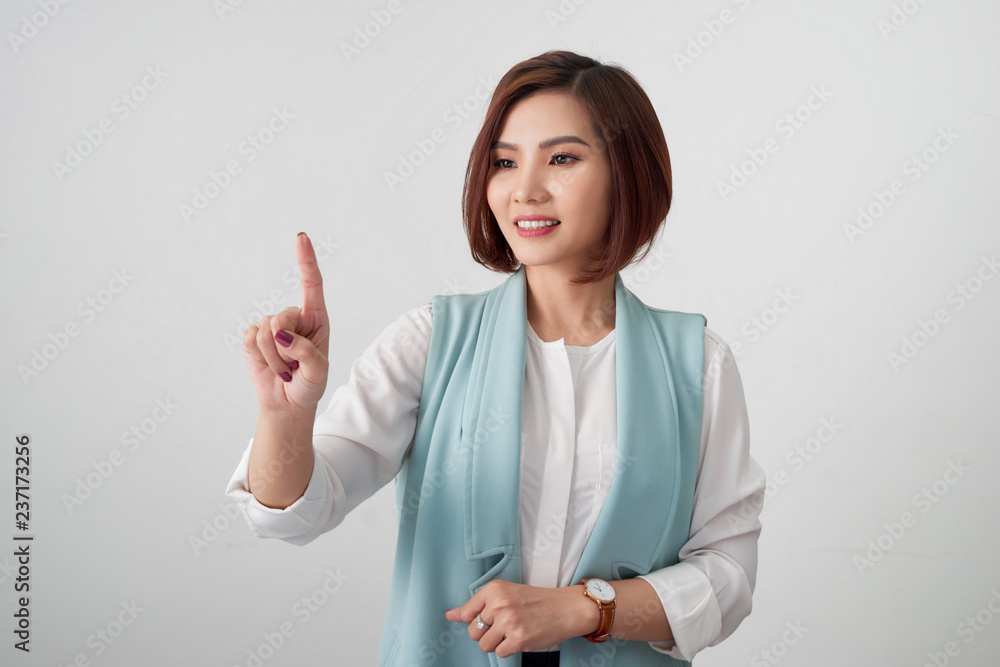 Young woman pointing at something on a white background Young woman pointing at something on a white background