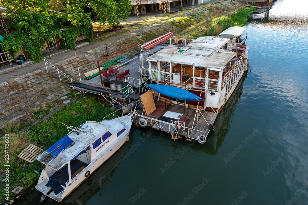 Naklejka premium Zrenjanin, Serbia - May 17, 2018: The Begej River passes through the town of Zrenjanin. Raft restaurant on the river.