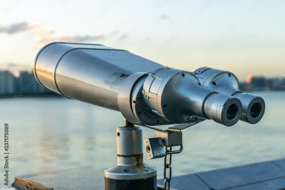 binoculars on background of city skyline binoculars on background of city skyline