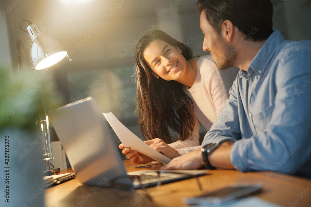 Good looking couple working on shared computer at home Good looking couple working on shared computer at home