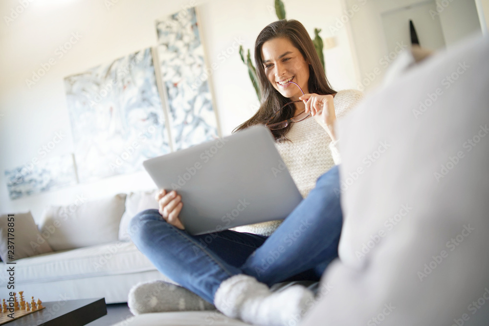 Beautiful woman relaxing at home with laptop Beautiful woman relaxing at home with laptop