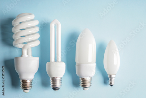 Different light bulbs on color background