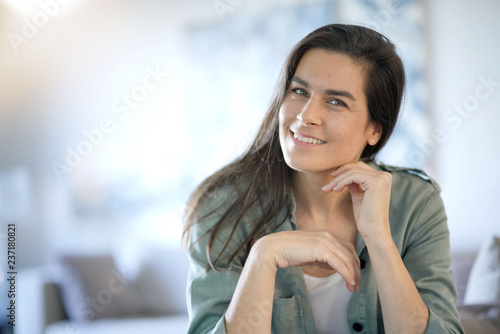 Free Download   Portrait of stunning brunette smiling indoors - GFXLoad