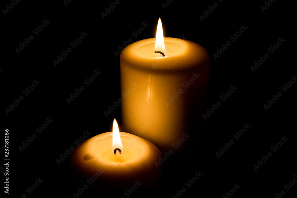 Burning candle in darkness