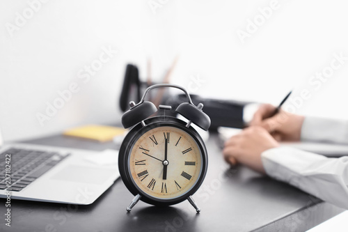 Alarm clock on dark table i...