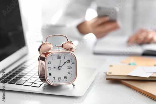 Alarm clock with laptop on ...
