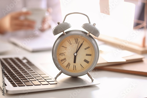 Alarm clock with laptop on ...